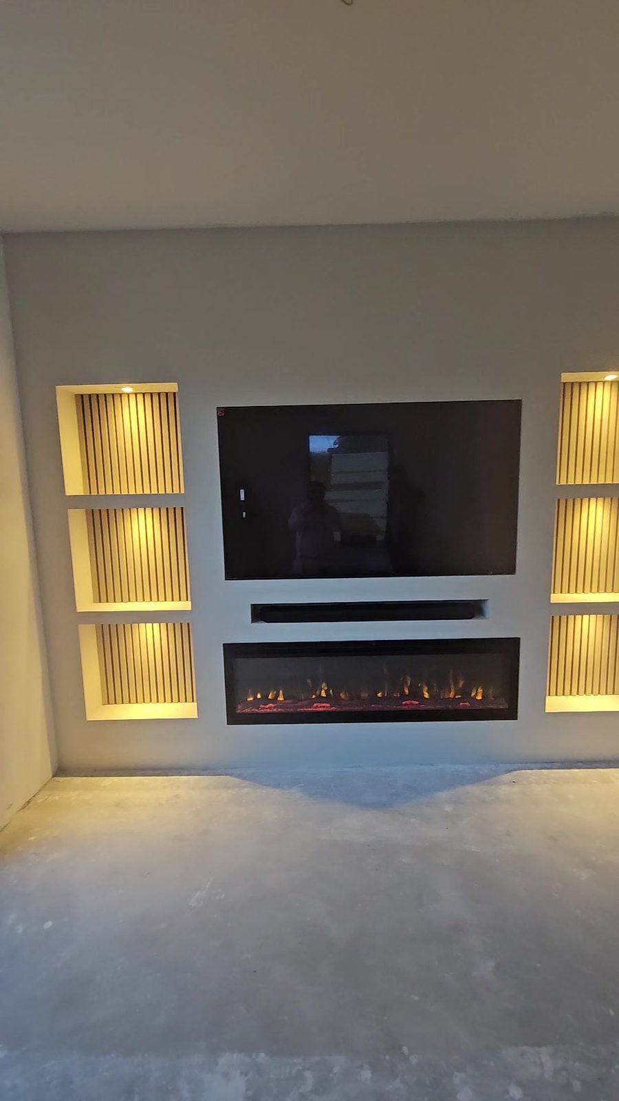 Cinewall in Amsterdam van voren met tv, soundbar en sfeerhaard