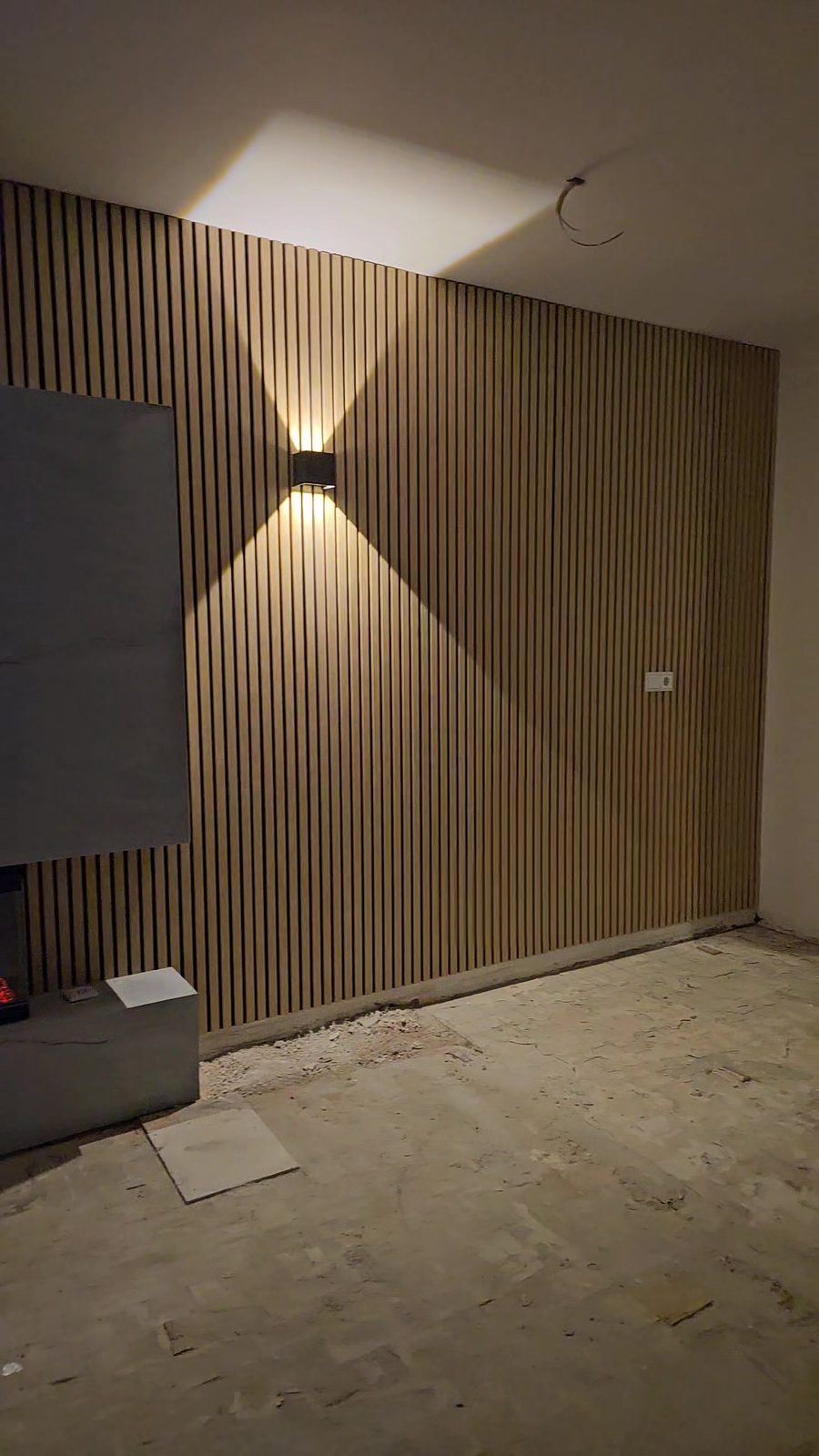 Detail van de houten wand met houten panelen met wandlamp in Utrecht